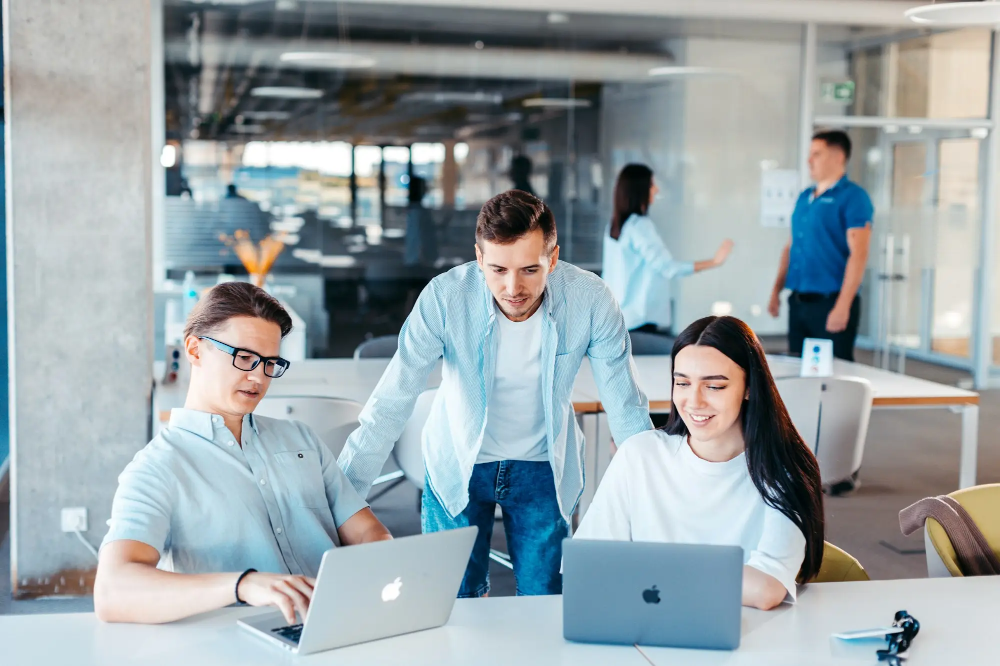 Small business team meeting around a table in a bright office
